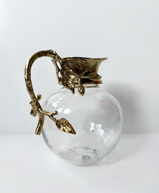 Glass Pitcher Adorned With A Gold Metal Handle