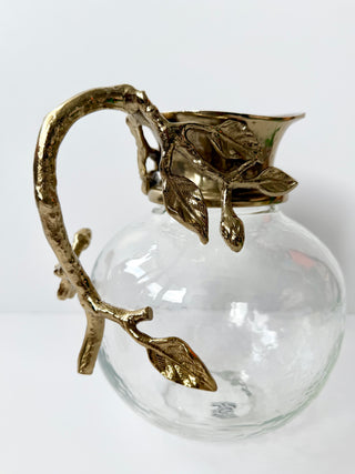 Glass Pitcher Adorned With A Gold Metal Handle