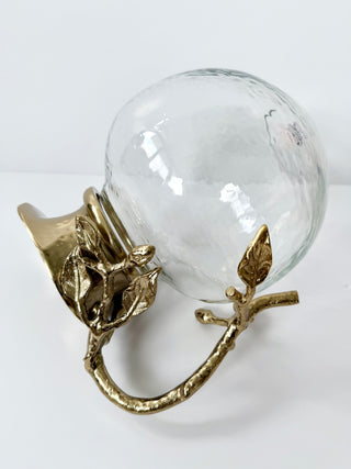 Glass Pitcher Adorned With A Gold Metal Handle