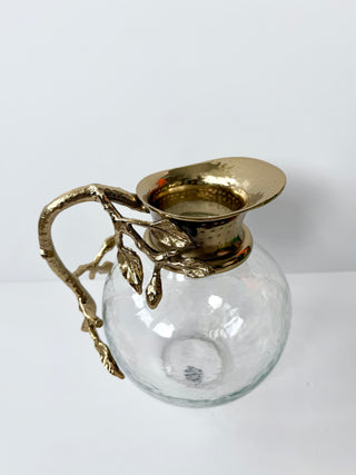 Glass Pitcher Adorned With A Gold Metal Handle
