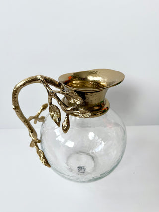 Glass Pitcher Adorned With A Gold Metal Handle